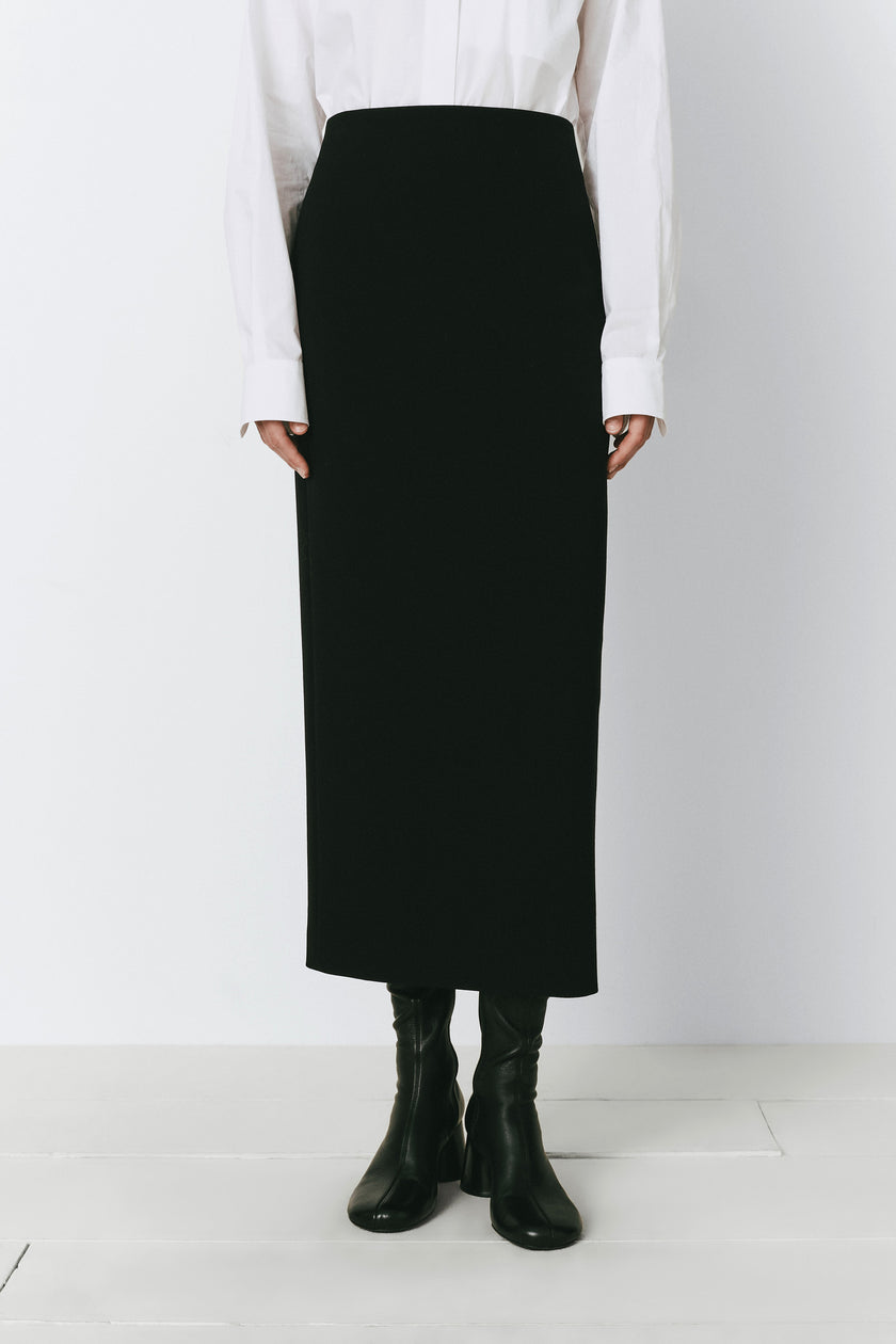 Black pencil skirt with back zip detail, tailored fit. Perfect for work and evening. Raoulet design.