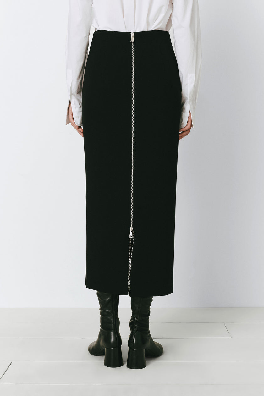 Black pencil skirt with back zip detail, perfect for work or evening wear. Raoulet design.