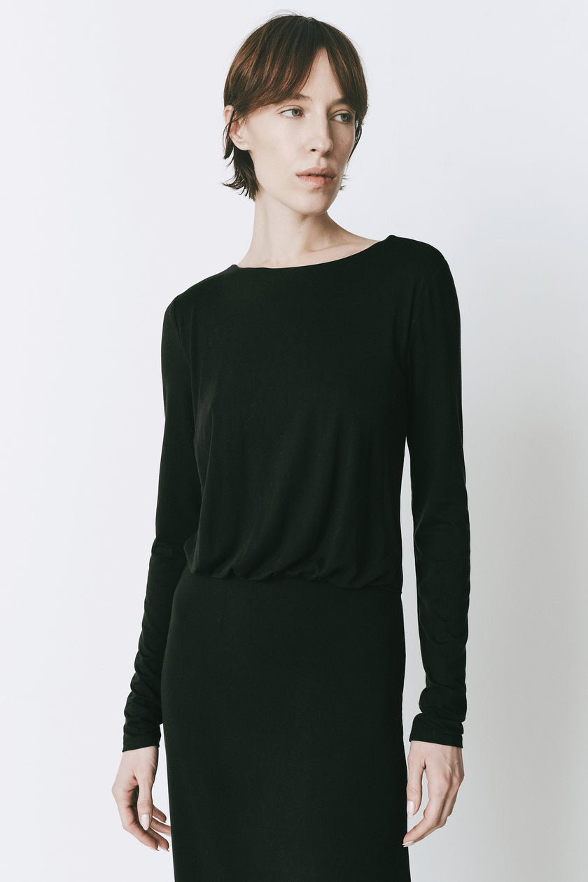 Black René Twist Back Dress with long sleeves and scoop neckline. Modern woman clothing.