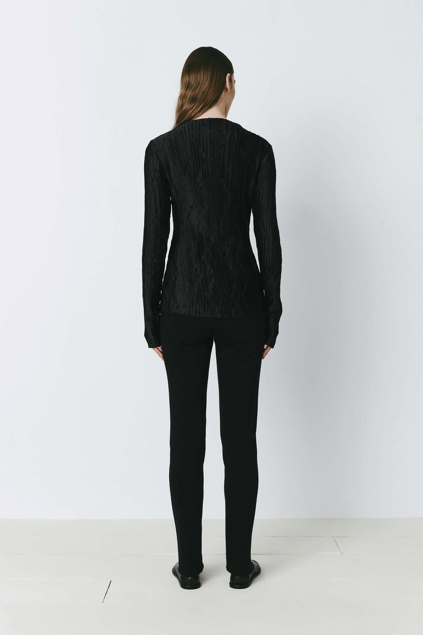 Black Sidonie Pleated Top with textured fabric and black tailored pants, perfect for evening wear.
