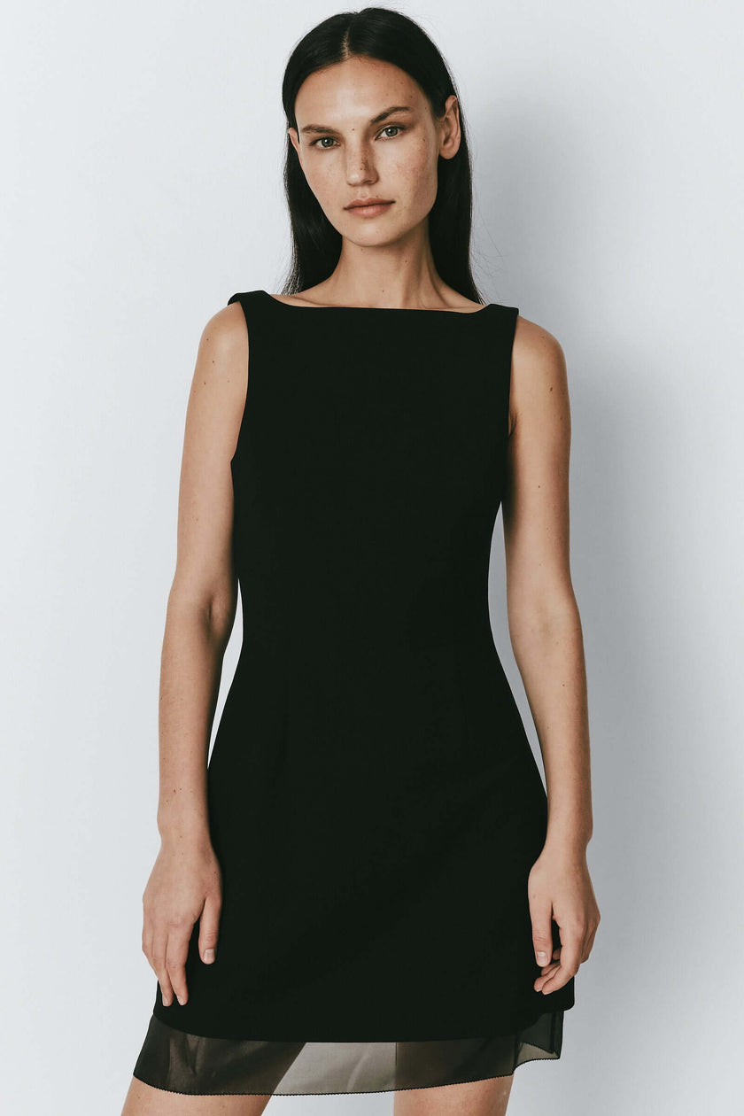 Yvette Boatneck Mini Dress in black. Featuring a flattering silhouette and organza details.