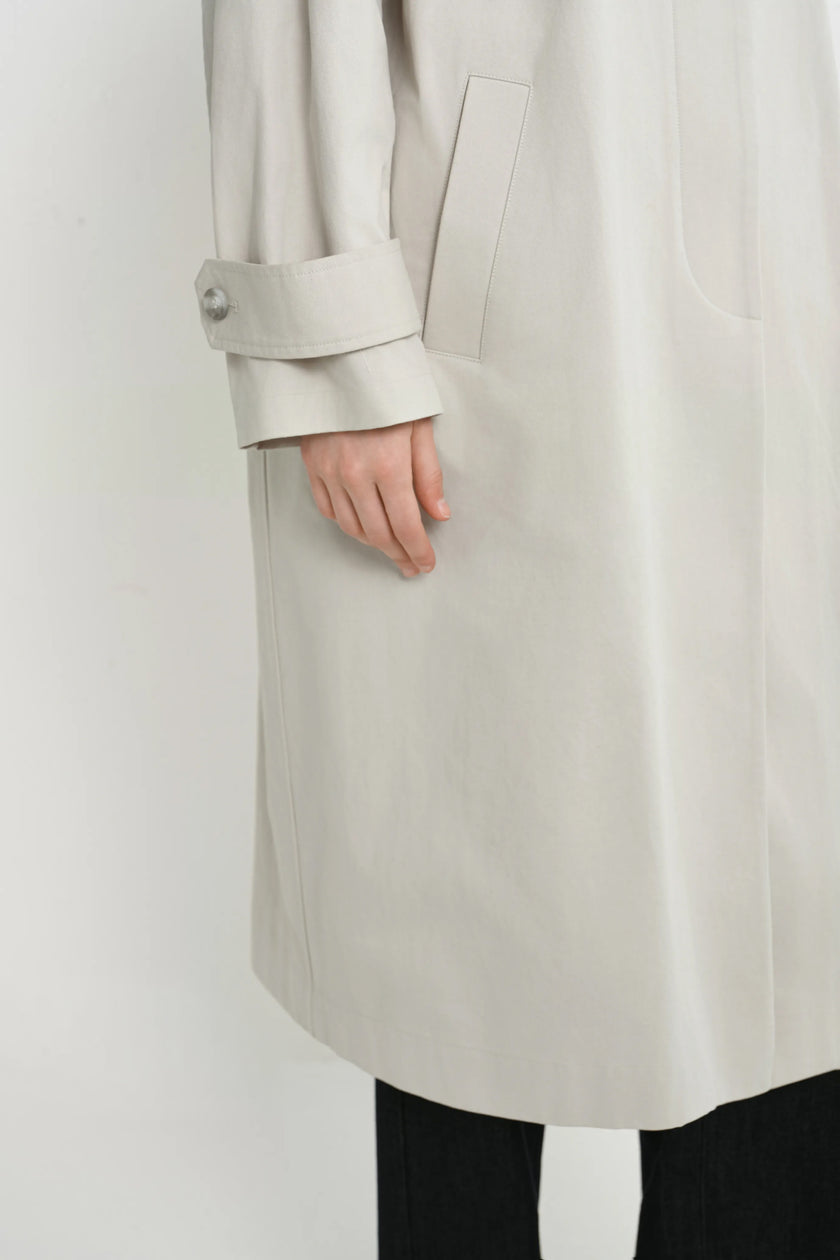 Close-up of the Rue Sophie Roche Oversized Jacket in cement, highlighting the adjustable buttoned cuff tab, side pocket, clean stitching, and smooth structured finish.