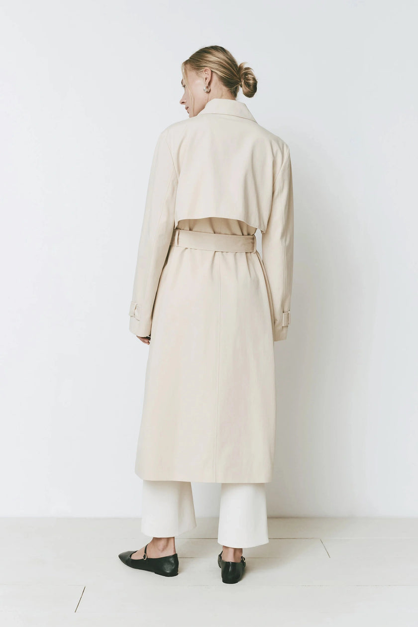 Beige Cassis Trench Coat with adjustable belt, wide collar, and relaxed fit, back view.