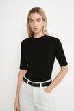 Close-up of the Rue Sophie Chabot Mock Neck Top in black, highlighting the mock neckline, smooth fitted construction, and elbow-length sleeves.