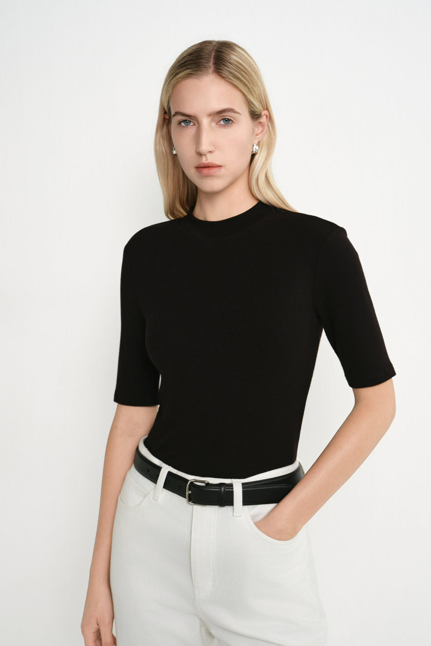 Close-up of the Rue Sophie Chabot Mock Neck Top in black, highlighting the mock neckline, smooth fitted construction, and elbow-length sleeves.