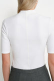 Back close-up of the Rue Sophie Chabot Mock Neck Top in cream, highlighting the mock neckline, fitted construction, center-back seam, and elbow-length sleeves.