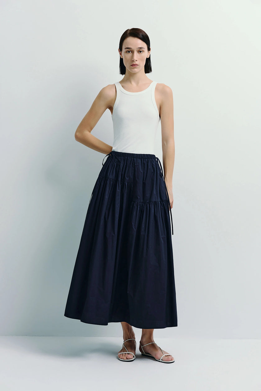 Etoile Voluminous Skirt in navy blue, made of 100% sustainable cotton, styled with a white tank top