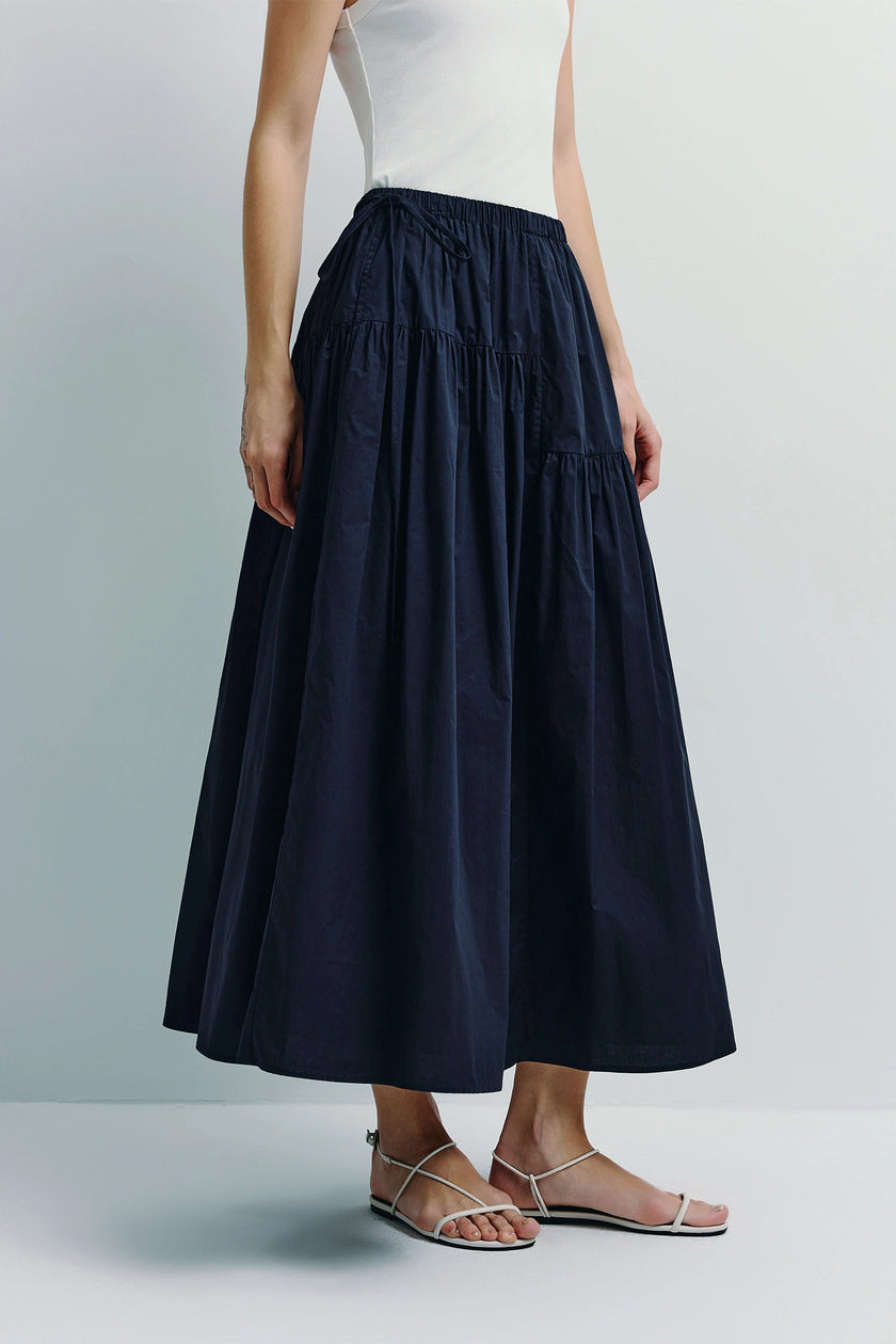 Navy blue Etoile Voluminous Skirt. A-line, sustainable cotton skirt styled with white tank top and sandals. Ruesophie.
