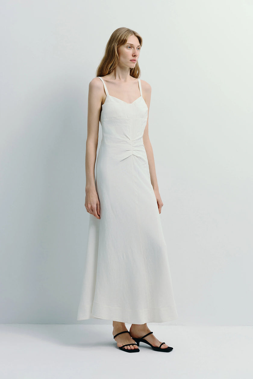 White Jiselle cami dress with pleated waist made from linen-viscose blend, woman wearing black sandals