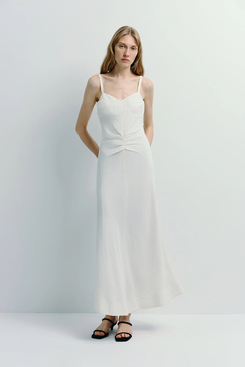 White Jiselle Pleated Waist Dress, linen-viscose blend cami, pleated waist, model in black sandals.