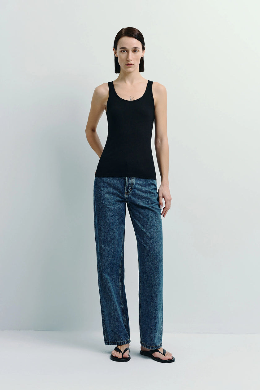 Black Finley Ribbed Tank Top and jeans. Sustainable cotton-viscose blend tank with a sleek fit, paired with jeans