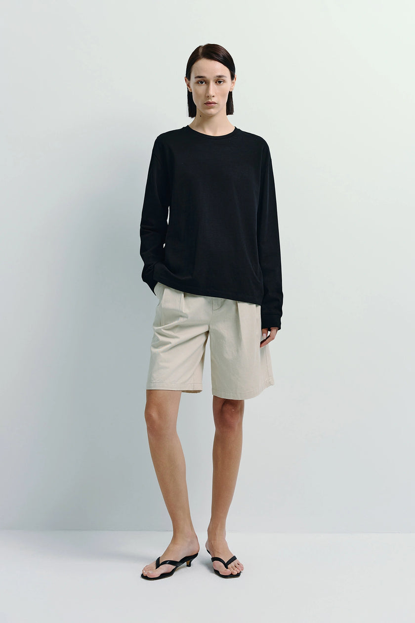 Anza Long Sleeve Top in black cotton blend, paired with beige shorts, minimalist fashion