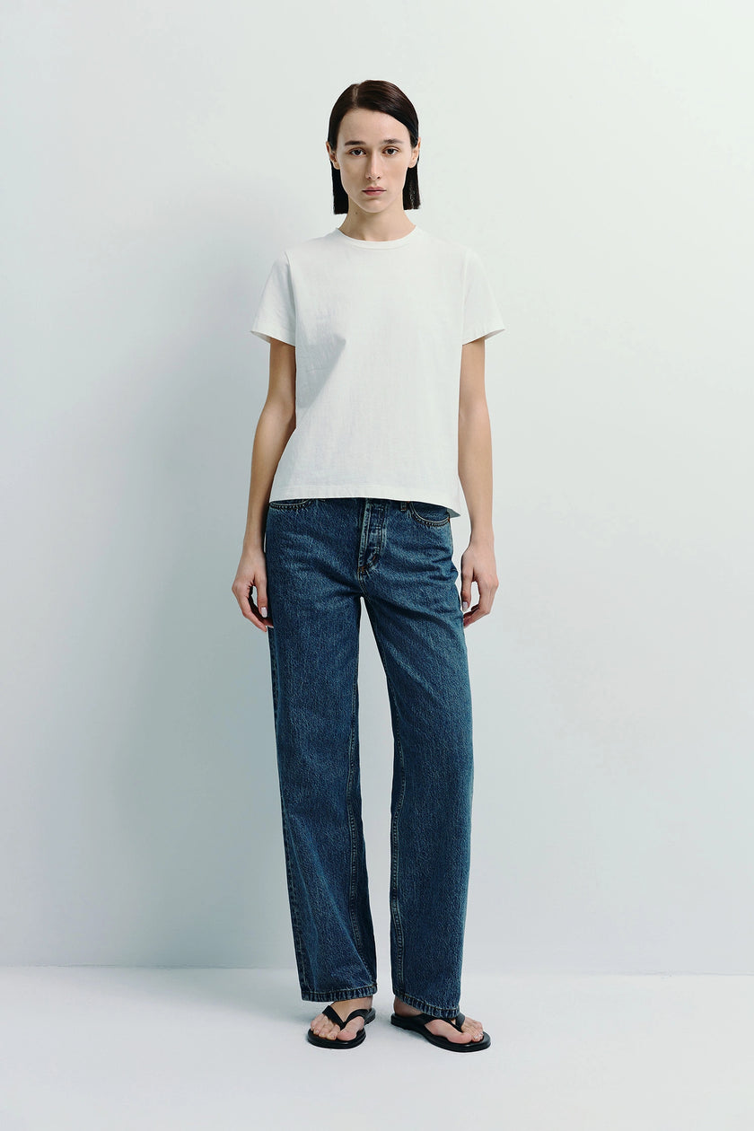Woman in white Fay Crew Neck Tee and denim jeans, made with sustainable cotton