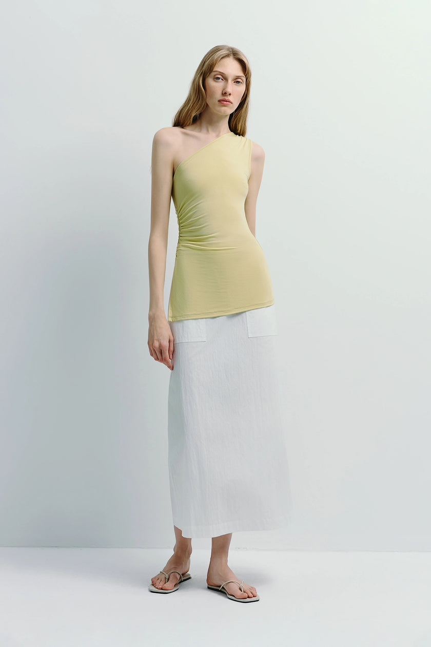 Model wearing Savoie Crinkled Poplin Skirt with elegant one-shoulder top, sophisticated and comfortable style.