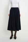 Front close-up of the Rue Sophie Panier Drawstring Waist Pleated Skirt in Navy, highlighting the drawstring waistband and softly gathered volume.