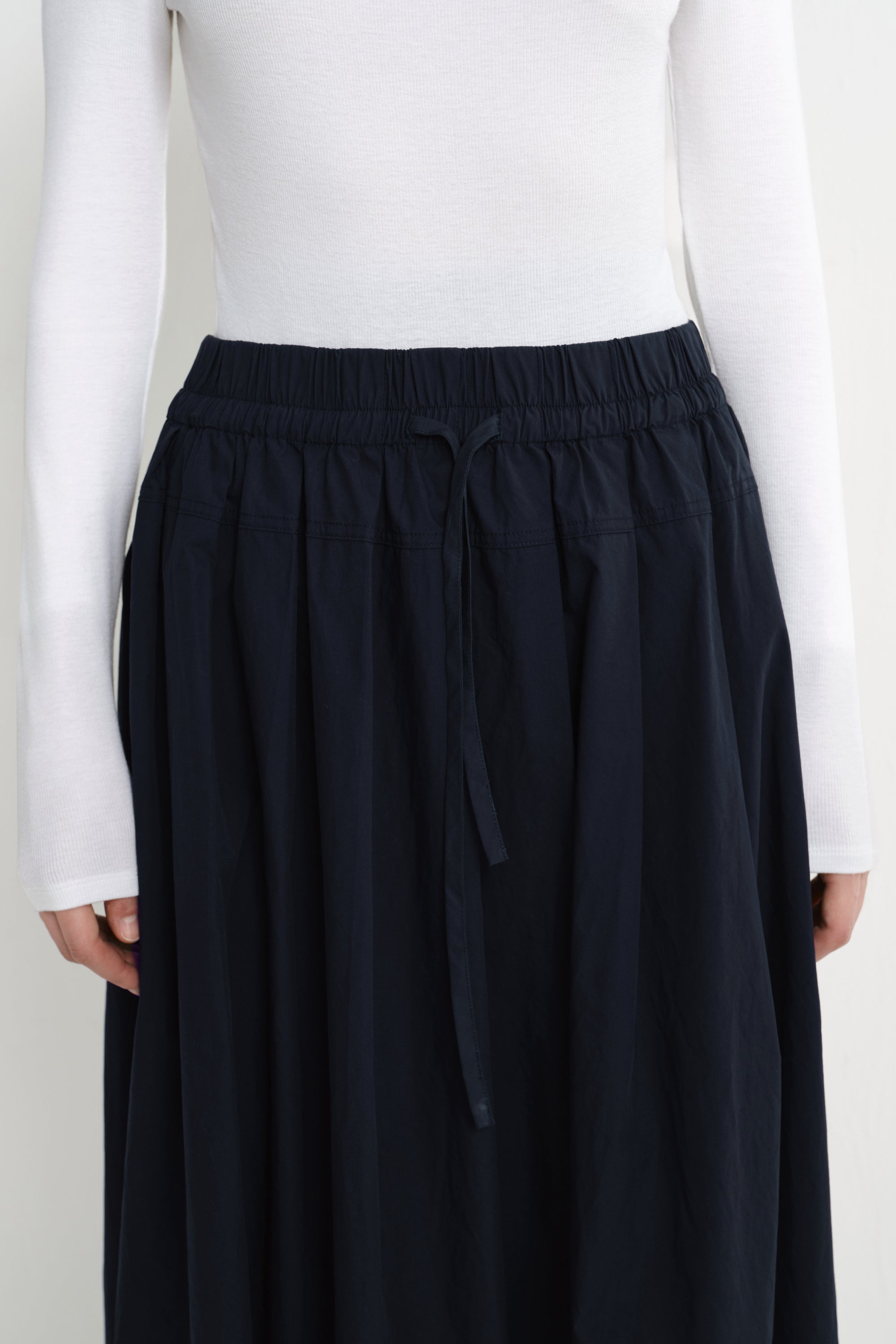 Close-up of the Rue Sophie Panier Drawstring Waist Pleated Skirt in Navy, highlighting the elasticated waistband, drawstring tie, and gathered detailing.