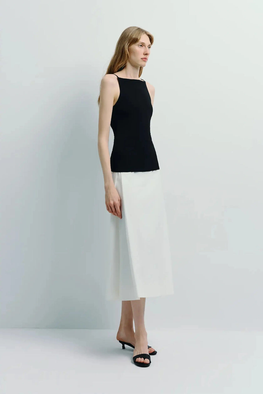 White Orléans Pocket Pleat Skirt with black top, minimalist style, A-line skirt