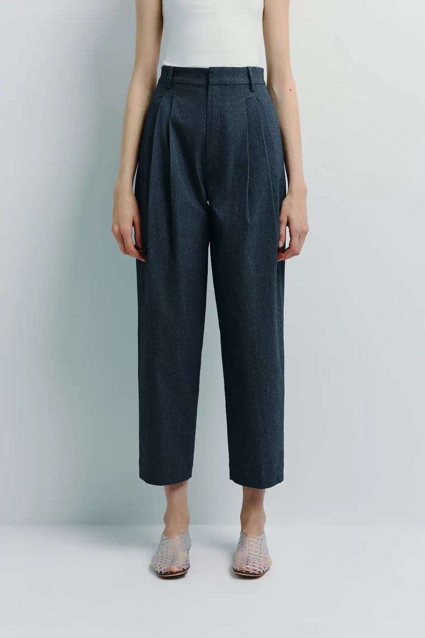 Campagne Pleated Tapered Pant in dark denim; High-waisted with front pleats and a tapered leg silhouette.