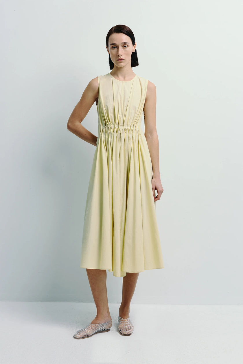 Pale yellow Toulouse Origami Pleat Dress with pleated bodice and flowing skirt