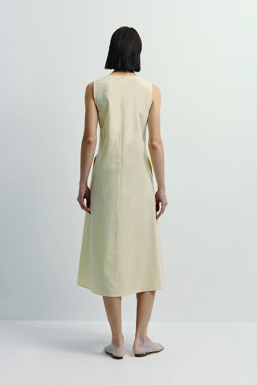Pale yellow Toulouse Origami Pleat Dress back view, sleeveless design and flowing skirt, designed for a striking statement.