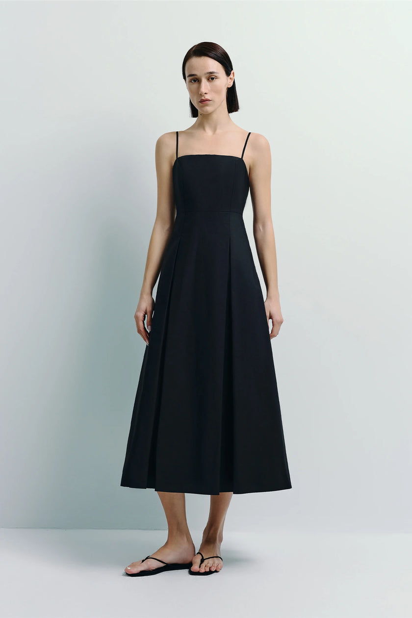 Nantes Pleat Front Cami Dress in black, showcasing a modern, fluid silhouette with soft pleat detailing