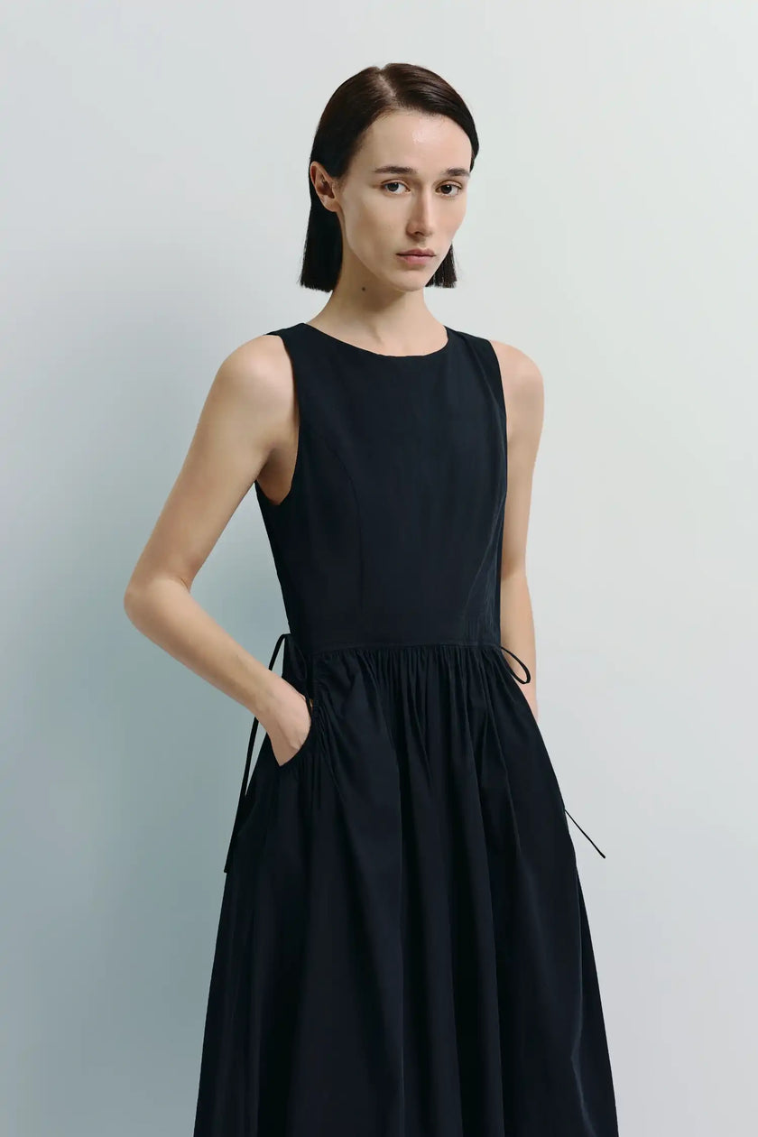 Black Tours Gathered Pocket Dress. Sleeveless, cotton-nylon blend with patch pockets and gathered waist detailing.