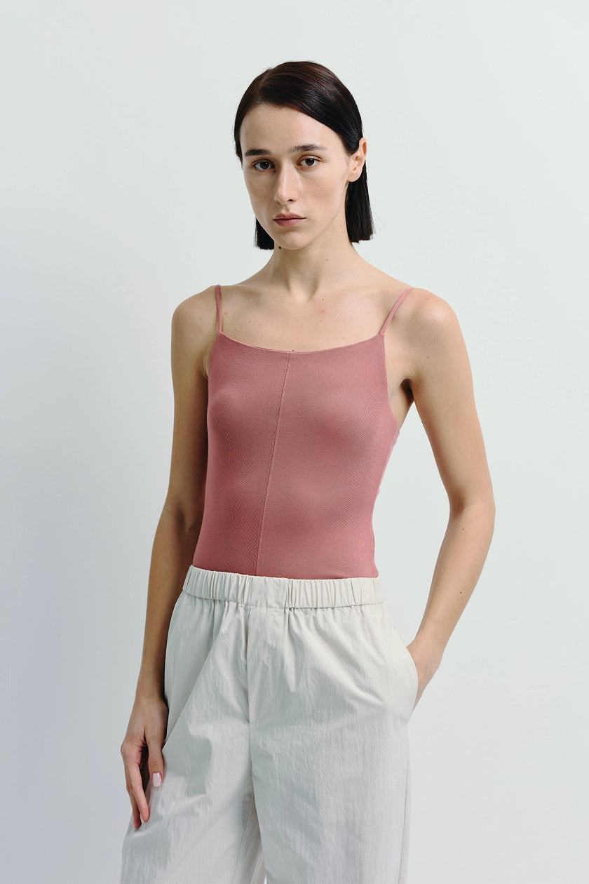 Dusty rose Aride Cami Bodysuit with thin straps, paired with light beige high-waisted pants