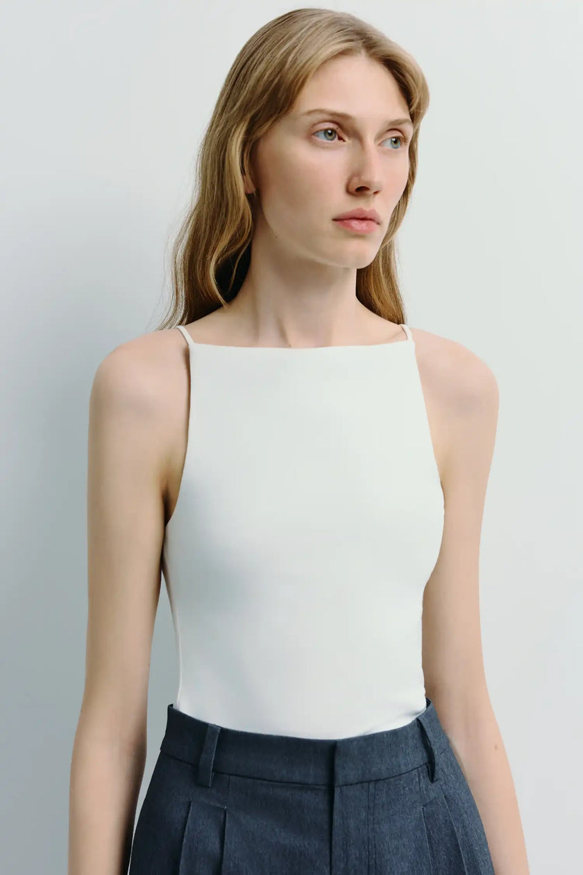 Chantilly Square Neck Cami Top in white, paired with dark blue tailored pants. Soft rayon blend with structured neckline.