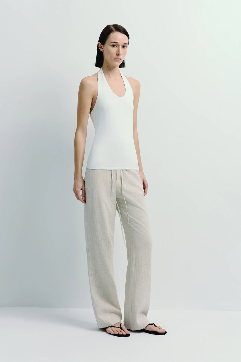 Chaleur Halter Top in white with beige linen pants. Minimalist, soft modal blend.