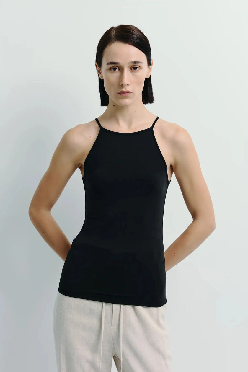Lola Halter Cami Top in black. Features delicate straps and a fluid fit. Crafted from a soft modal blend for a refined look.