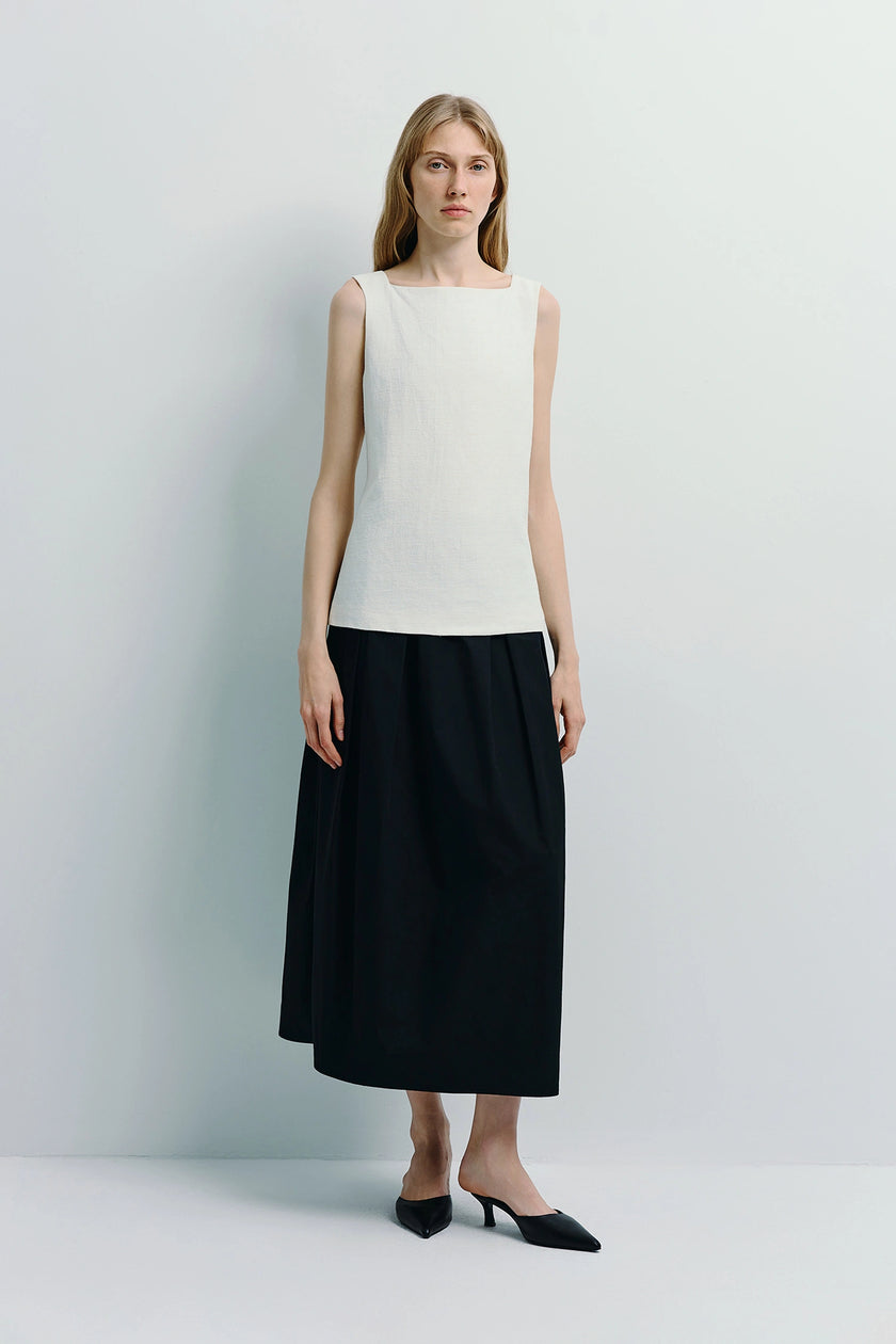 Woman wearing white Carré High Square Neck Top and black skirt, linen-cotton blend top