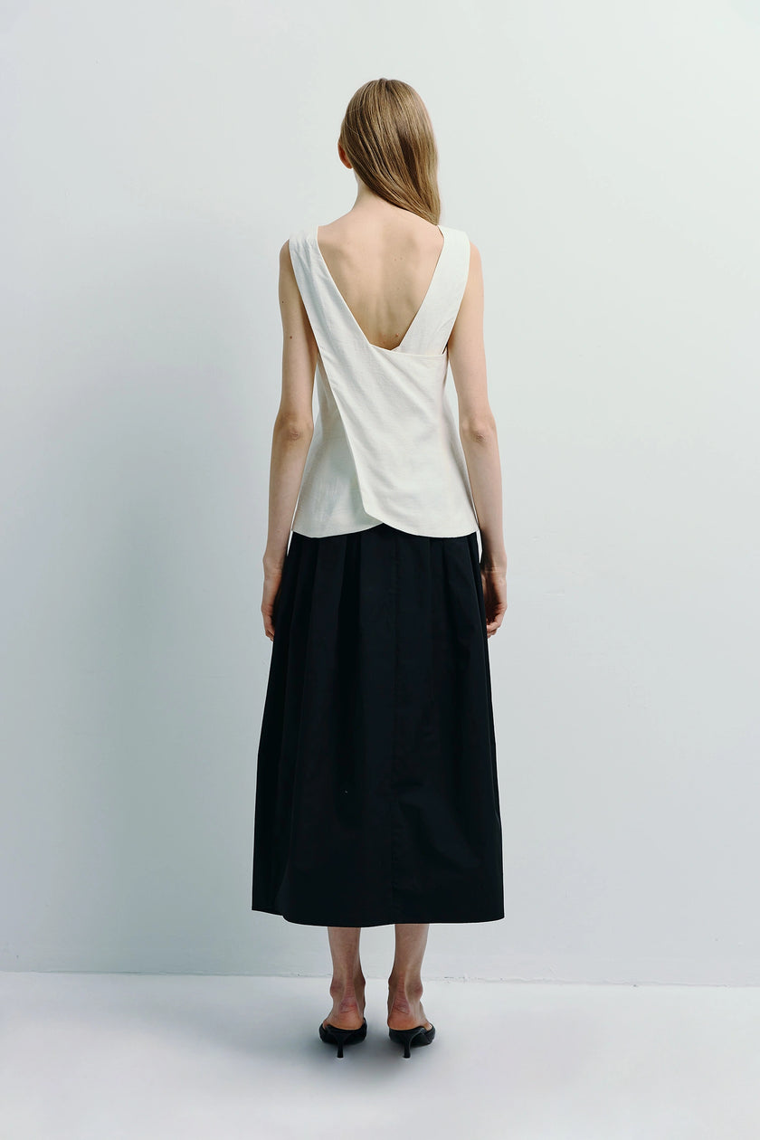Back view of Carré High Square Neck Top in white linen-cotton blend, paired with black skirt