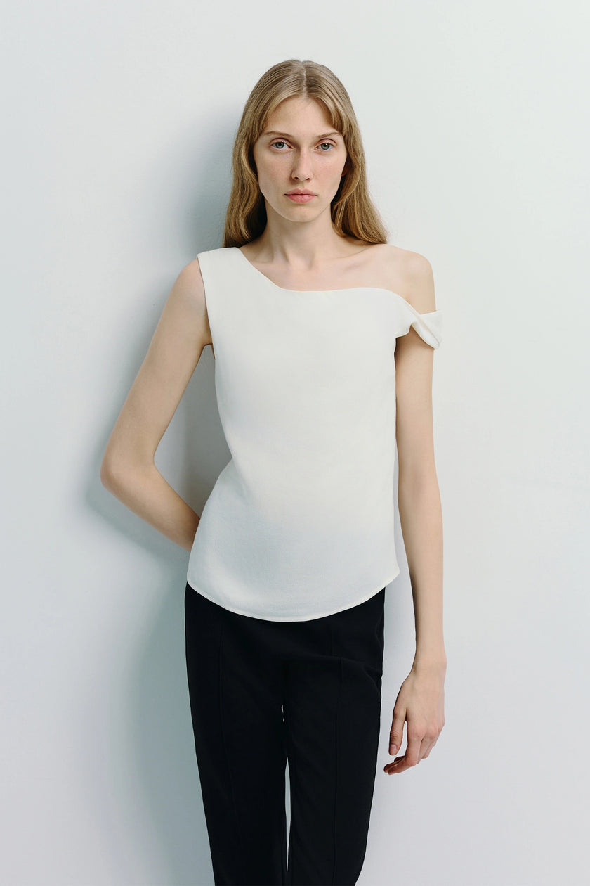 Jolie Off Shoulder Top in white with black pants. Modern silhouette from Rue Sophie.