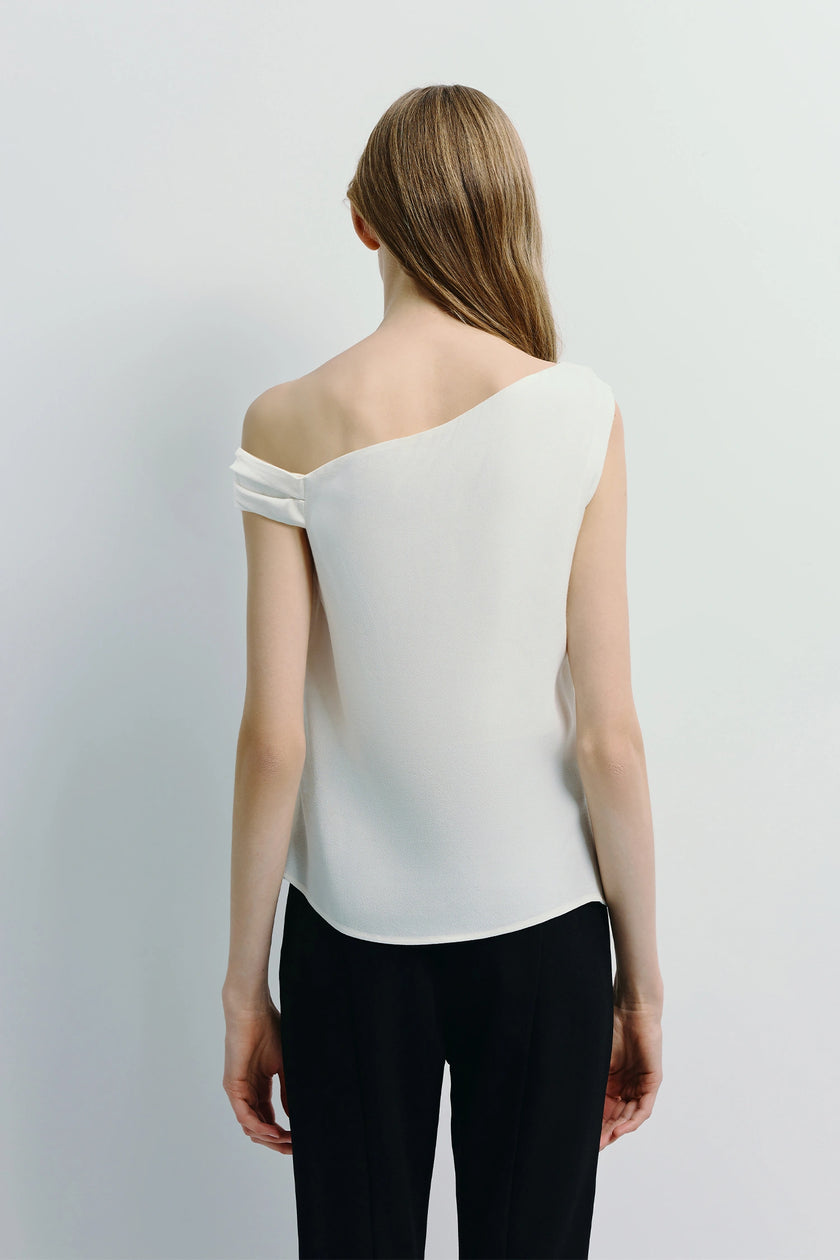 Jolie Off Shoulder Top in white with black pants. Modern, elegant back view silhouette.