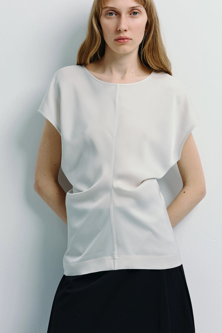 Ivory Bureau Dolman Top with black skirt, featuring dolman sleeves and structured silhouette.