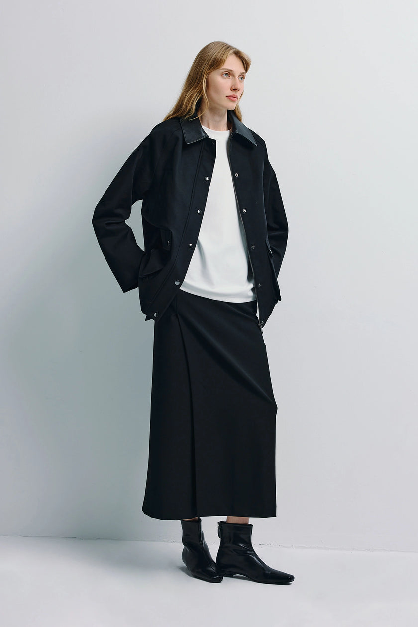 Black Bex Open Side Midi Skirt, paired with a black jacket and white top, minimalist style.