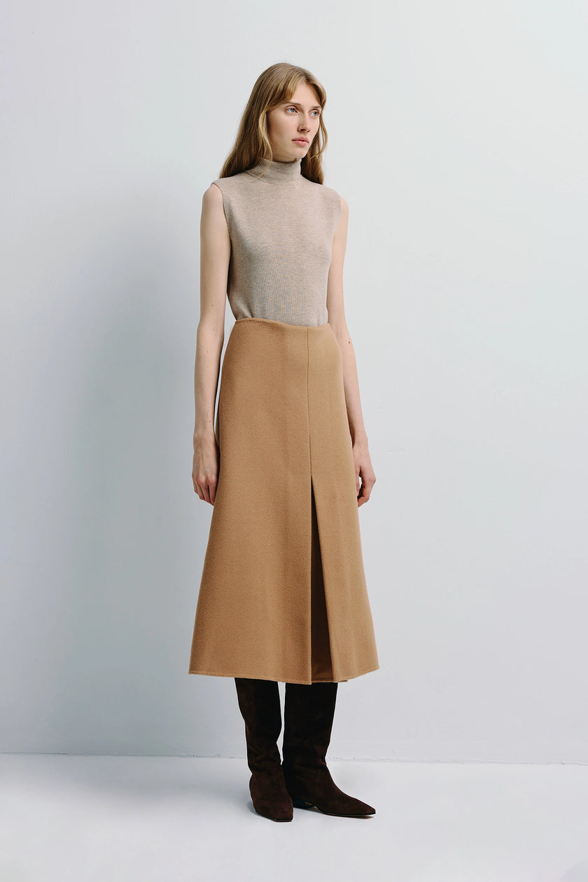 Woman in Rue Sophie Ambre Pleat Front Midi Skirt, camel wool-cashmere, A-line silhouette