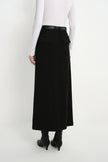Back view of a model wearing the Rue Sophie Camberly Midi Skirt in black, featuring a high waist, belt loops, flap back pockets, and center-back seam.