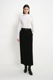 A model wearing the Rue Sophie Camberly Midi Skirt in black, featuring a high waist, clean center-front seam, and streamlined A-line silhouette, full-length front view.