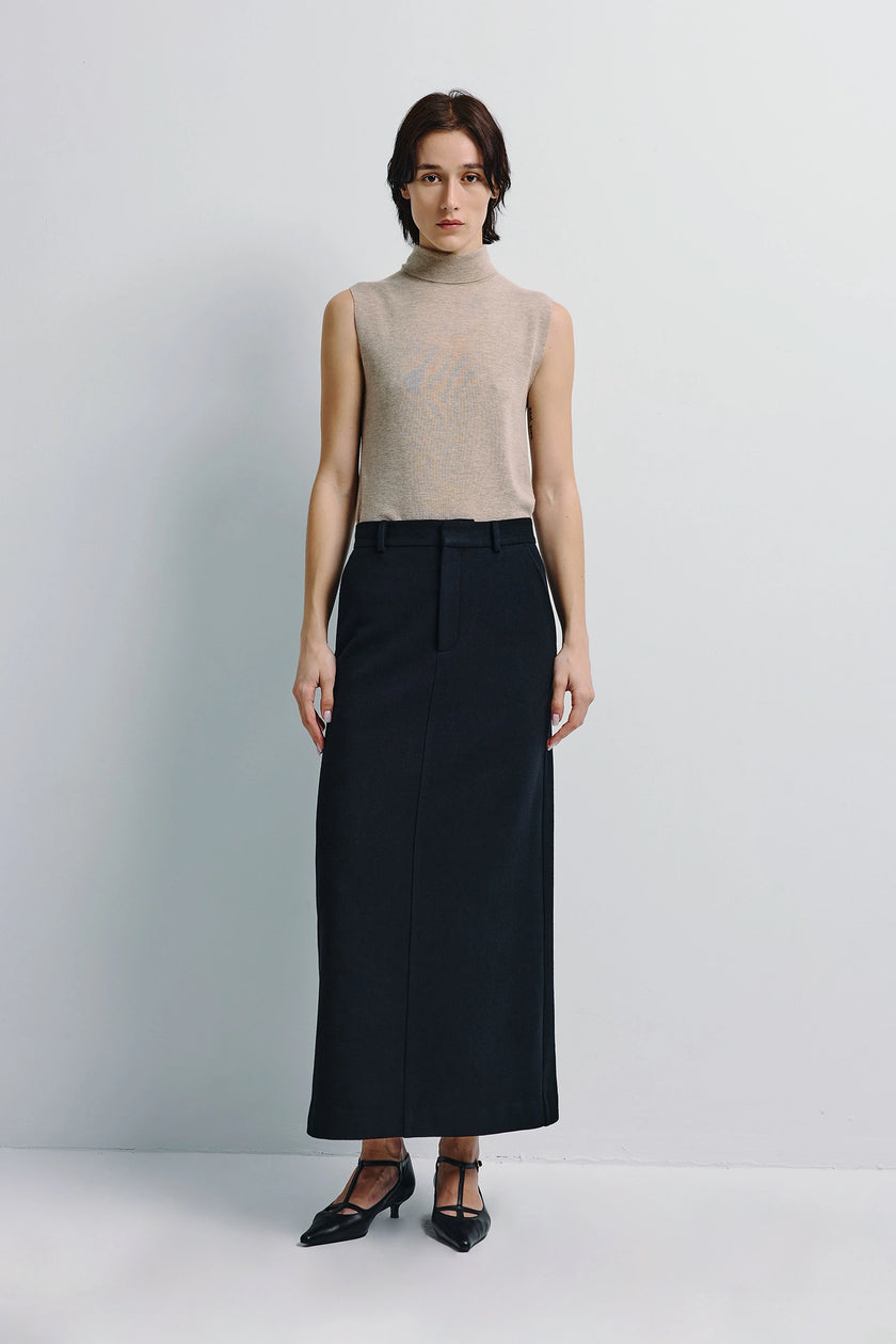 Ruesophie Camberly midi skirt in black, paired with a beige sleeveless top, elegant minimalist design