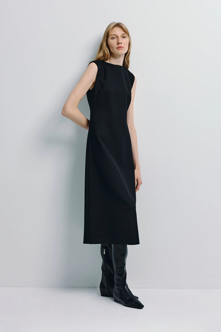 Black Roze A-line Midi Dress with boatneck and A-line silhouette, styled with black boots
