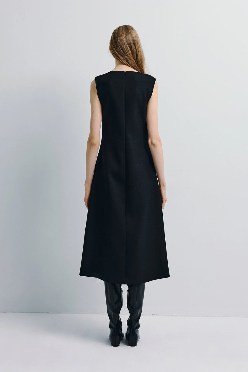Black Roze A-line midi dress, rear view, boatneck, paired with black boots, structured stretch blend