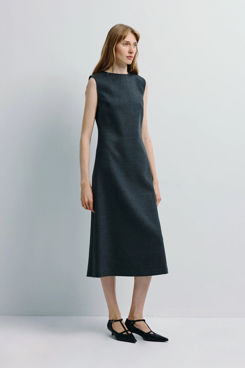 Dark grey A-line midi dress with a boatneck and midi length on a model