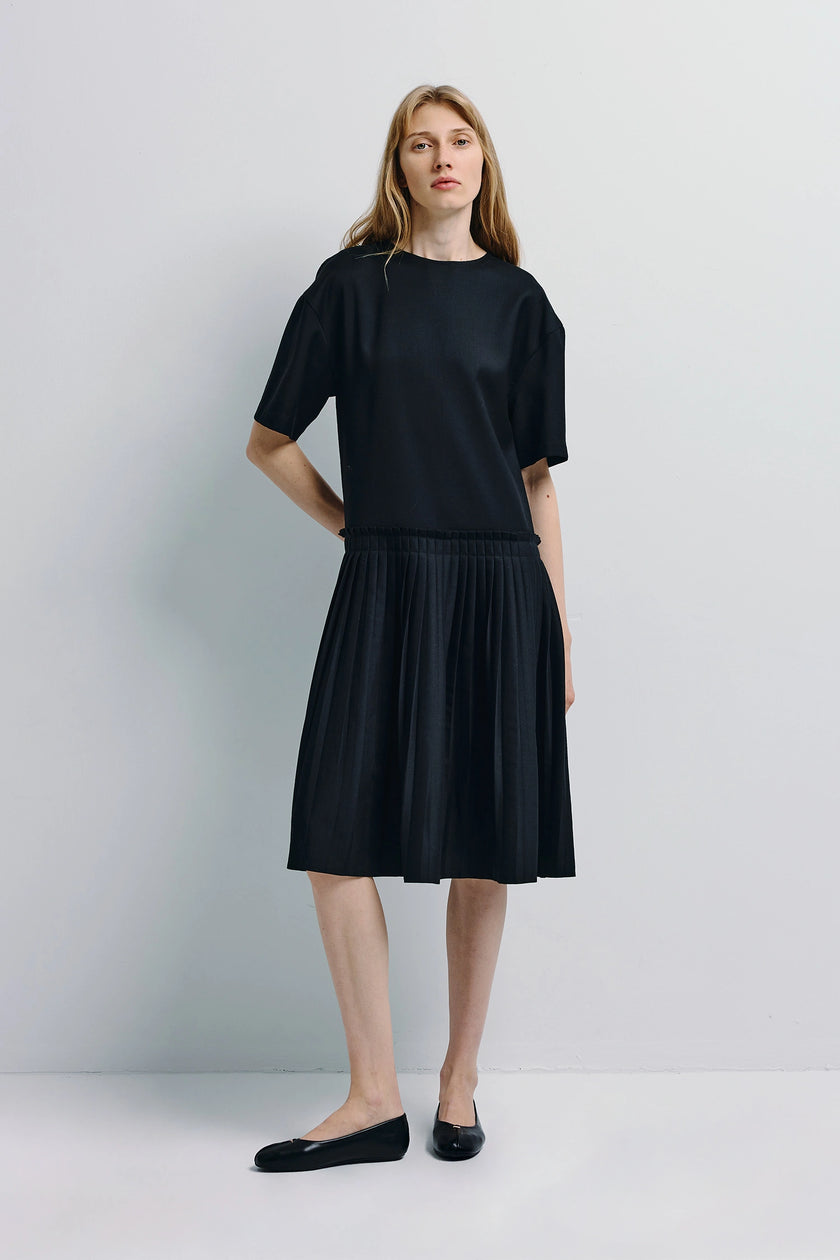 Lohan Pleated Skirt Dress in black wool-blend with pleated skirt. Architectural design.