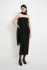 A model wearing the Rue Sophie Webster Tube Dress in black with a straight strapless neckline and fitted column silhouette, styled with a sheer black scarf, three-quarter front view.