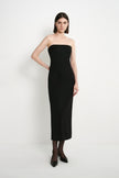 A model wearing the Rue Sophie Webster Tube Dress in black, featuring a clean strapless neckline, shaped waist seams, and a fitted column silhouette, front view.