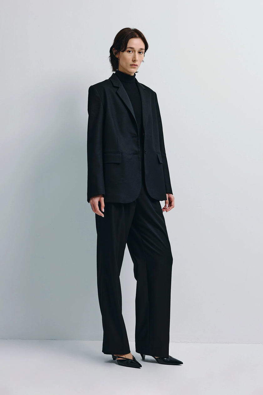Black Neil Blazer and Pant Set. Tailored, single-breasted blazer paired with matching trousers, minimalist style.