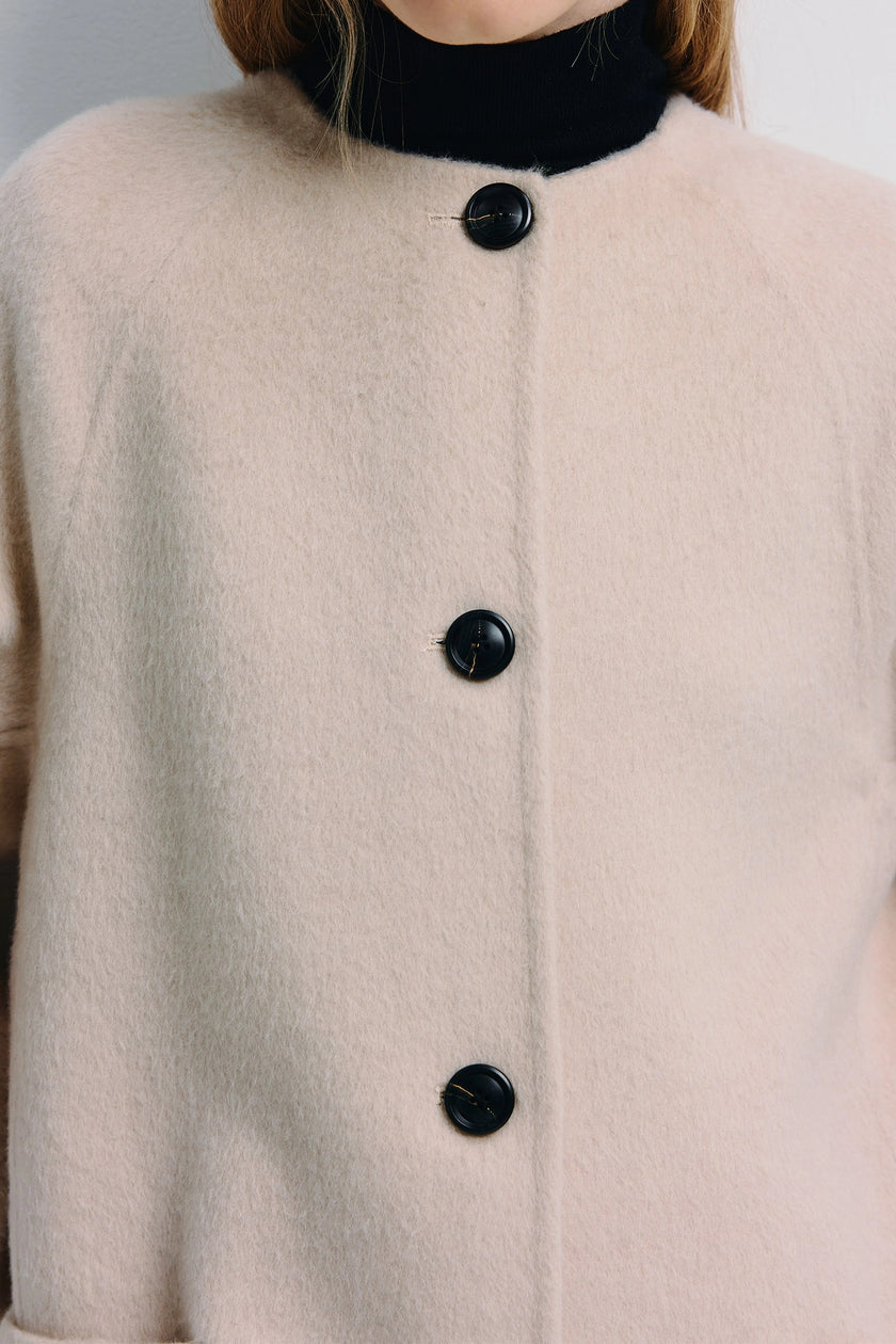 Iana Collarless Handmade Coat in light beige with black buttons