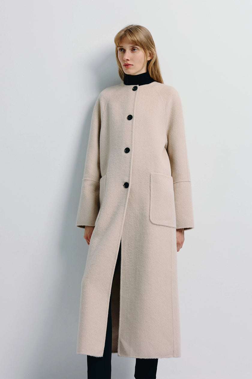 Iana Collarless Handmade Coat in light beige wool-alpaca blend with black buttons and kangaroo pockets