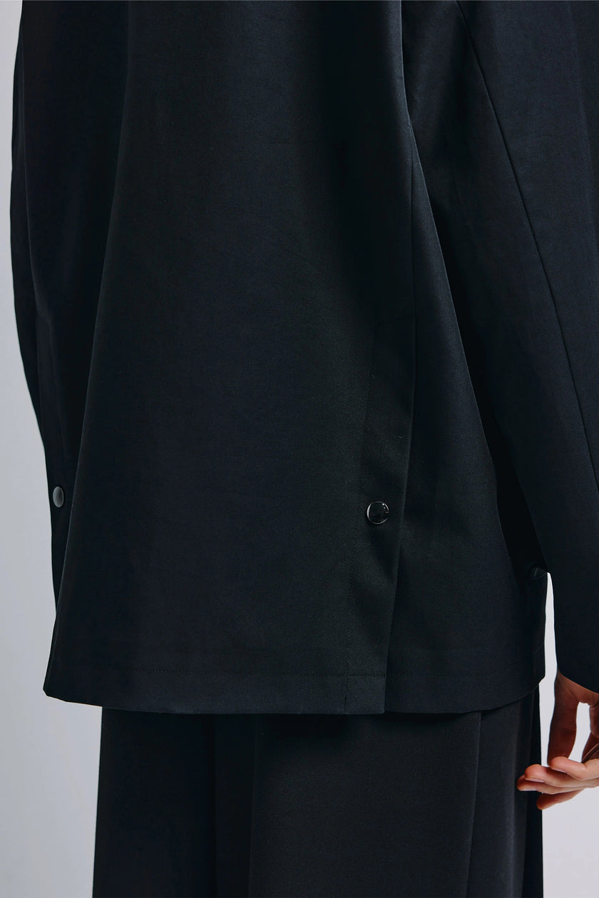 Black Roth Barn Jacket side detail, featuring button and tailored fit outerwear.